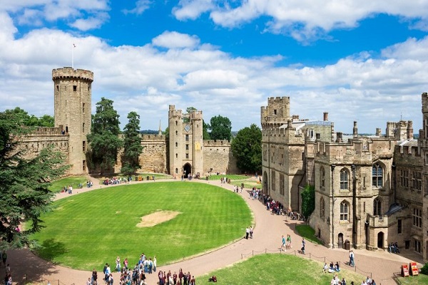 Stone towers and a wide lawn at Warwick Castle